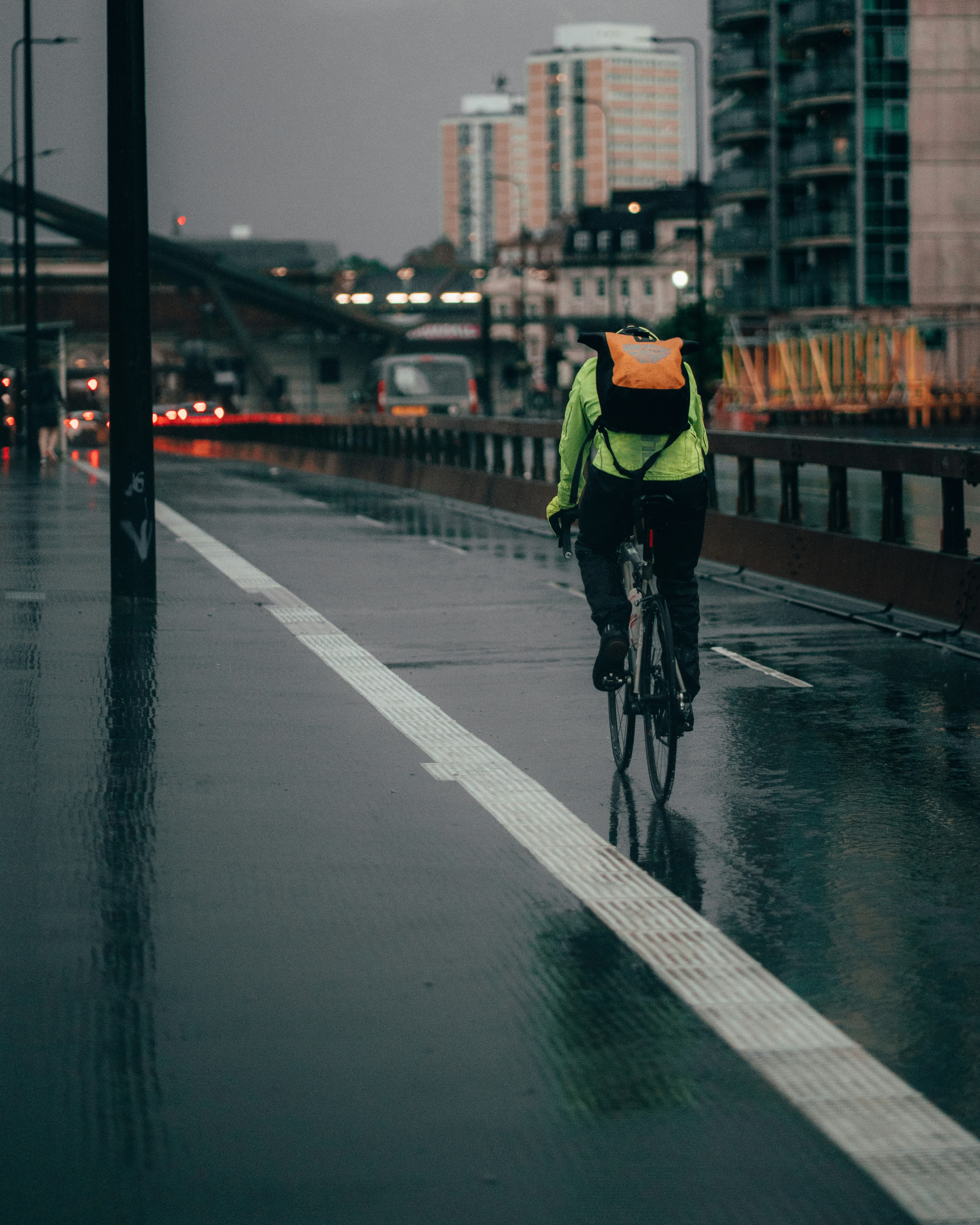 man in yellow shirt riding bicycle on road during daytime